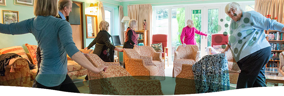 Sarah teaching a standing class in a bright room